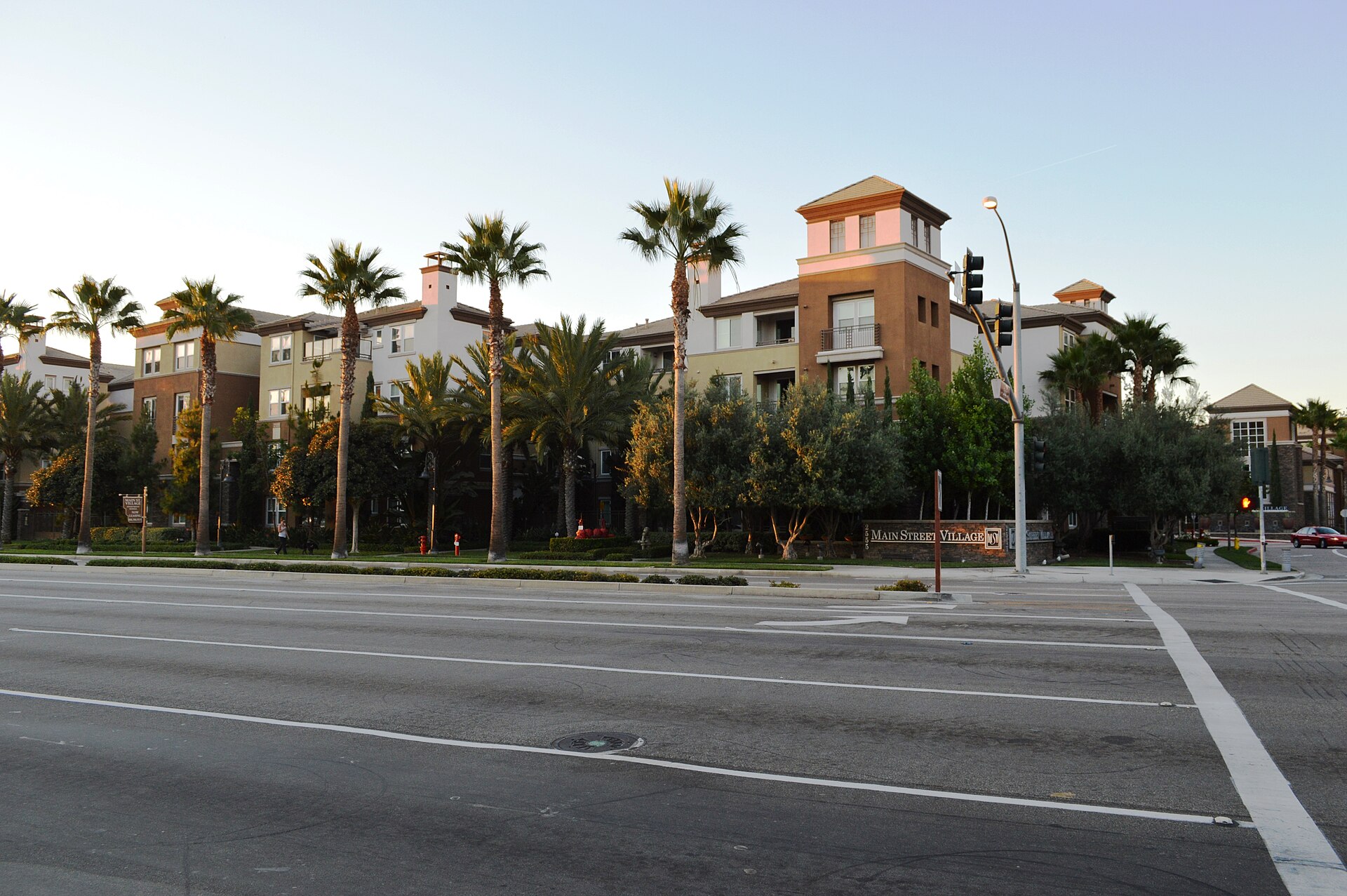 Main Street Village apartments in Irvine, with warm stucco buildings and mature palms.